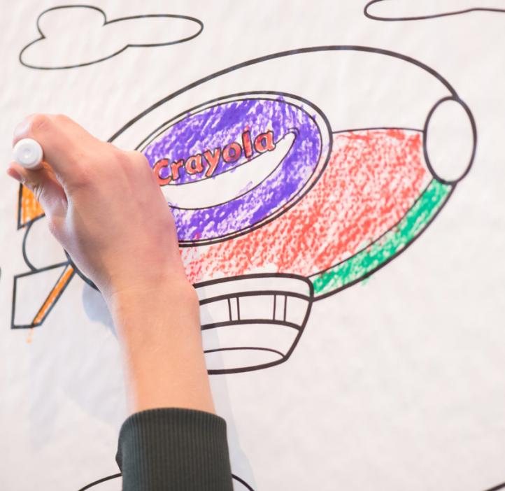 child coloring blimp on paper