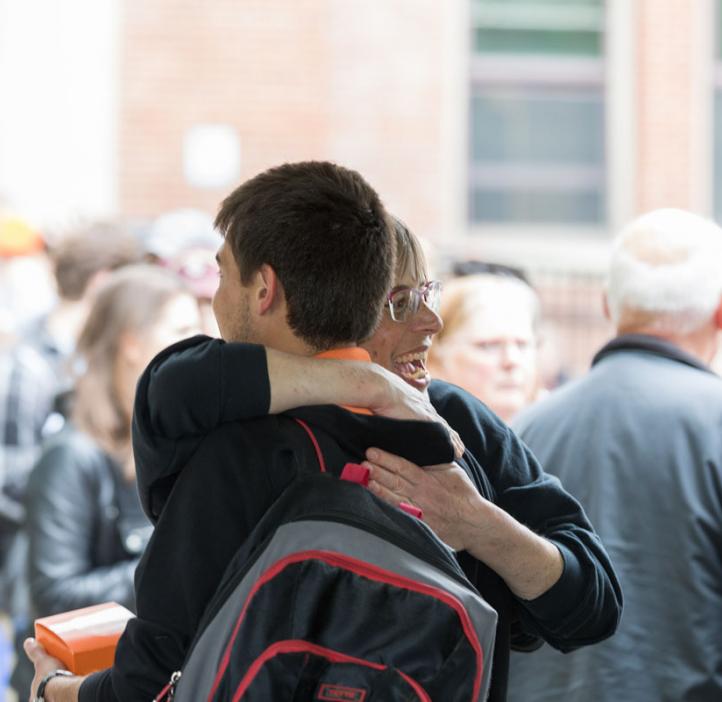 Karen Van Zee hugging student