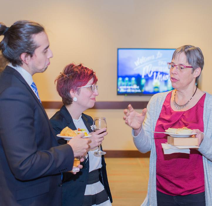 Faculty and staff chatting over food