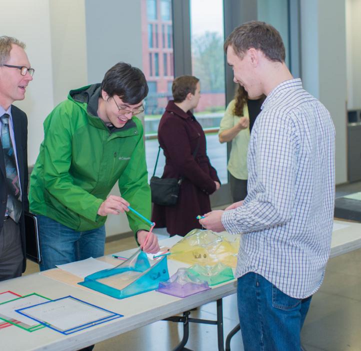 Roy Haggerty talking with students and club booth