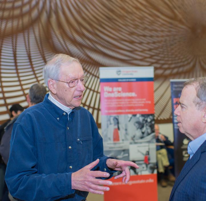 male colleagues chatting in front of art piece