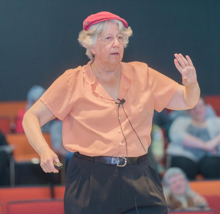 Corinne Manogue speaking on stage