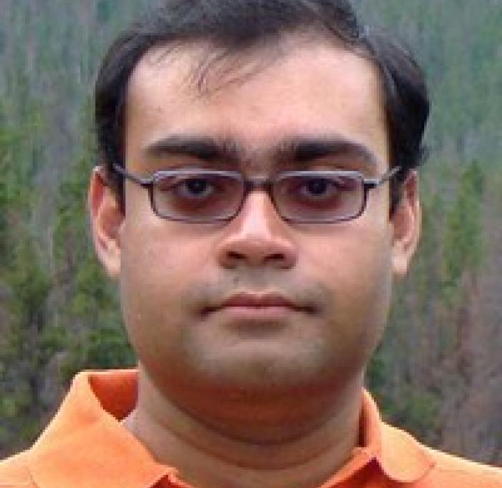 Sharmodeep Bhattacharyya in front of shrubbery