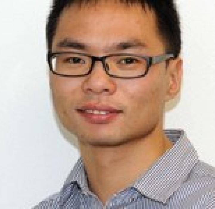 Bin Zhuo in front of white backdrop