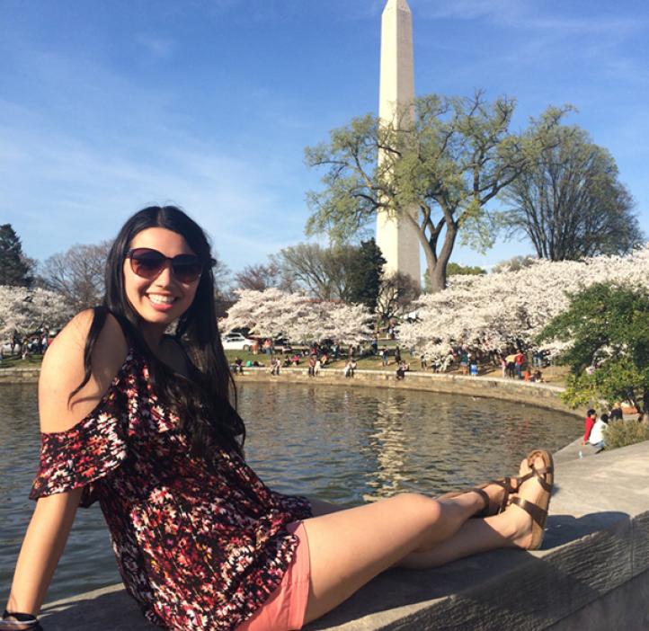 Mathematics major Josey Sechrist sitting in park next to fountain