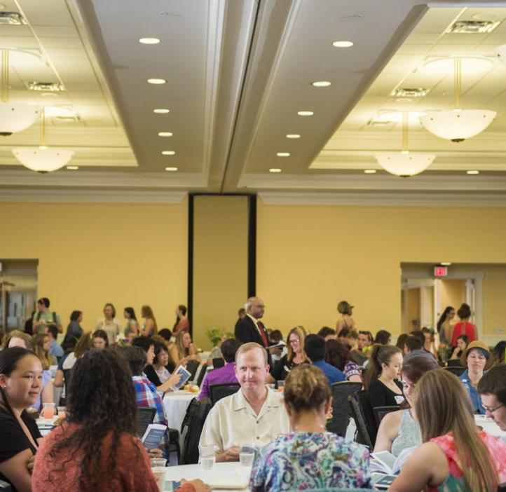 audience enjoying refreshments at tables