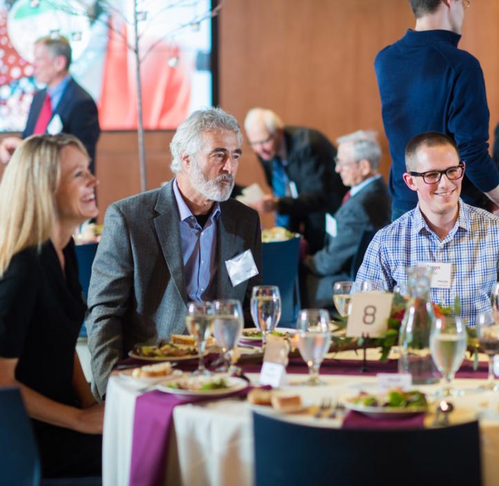 Stephen Giovannoni talking with colleagues at table