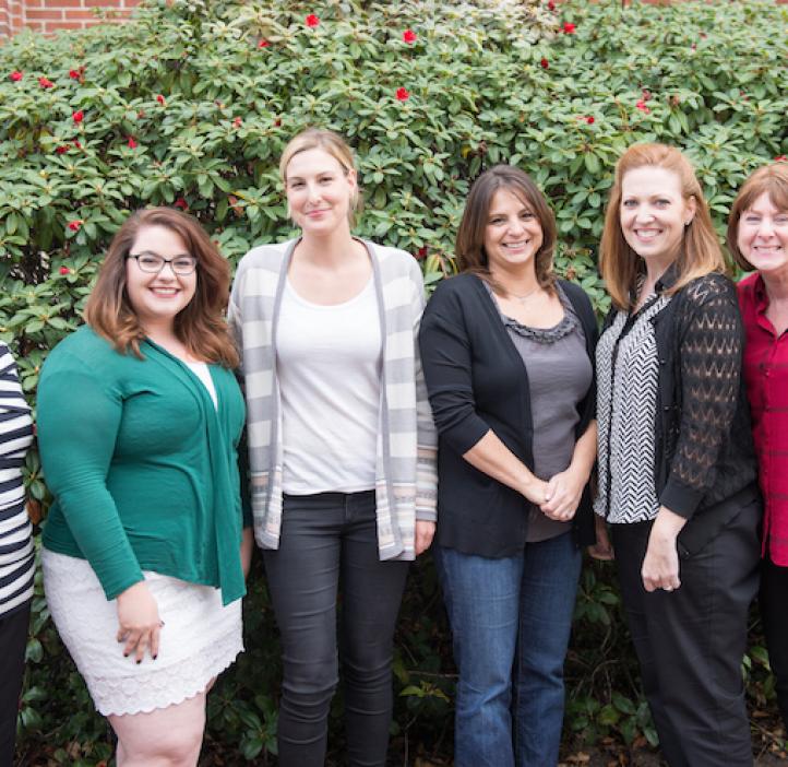 A & S Business Center team in front of shrubbery