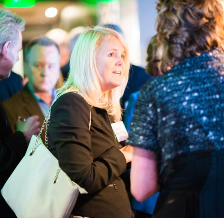 alumni talking in crowd