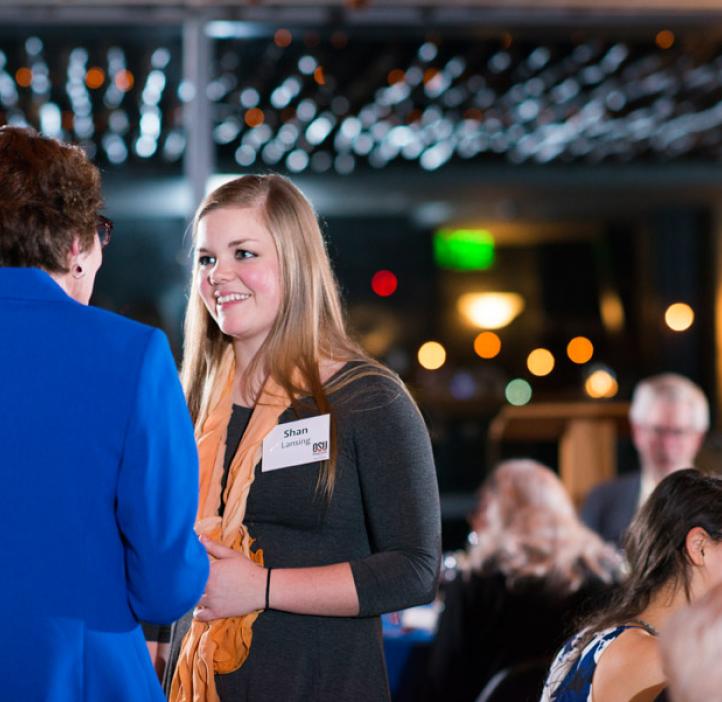 Shan Lansing talking with colleagues