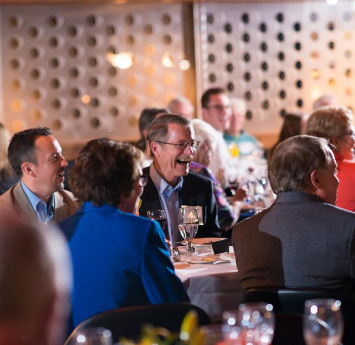 David Vernier laughing at table with colleagues