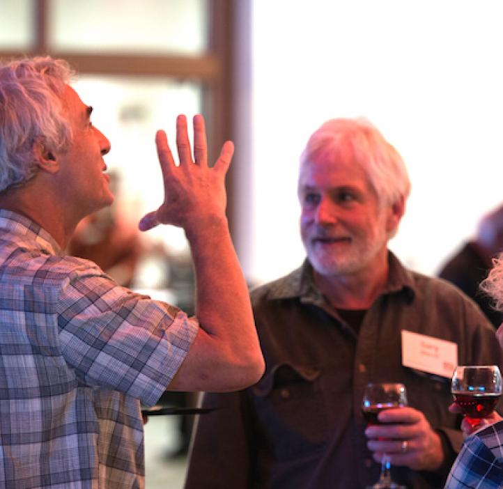 Steve Giovannoni talking with colleagues in lobby