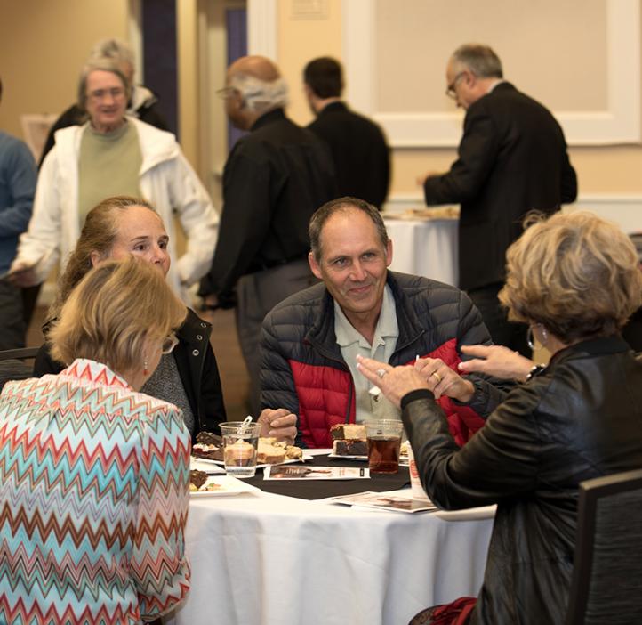 Colleagues talking at table