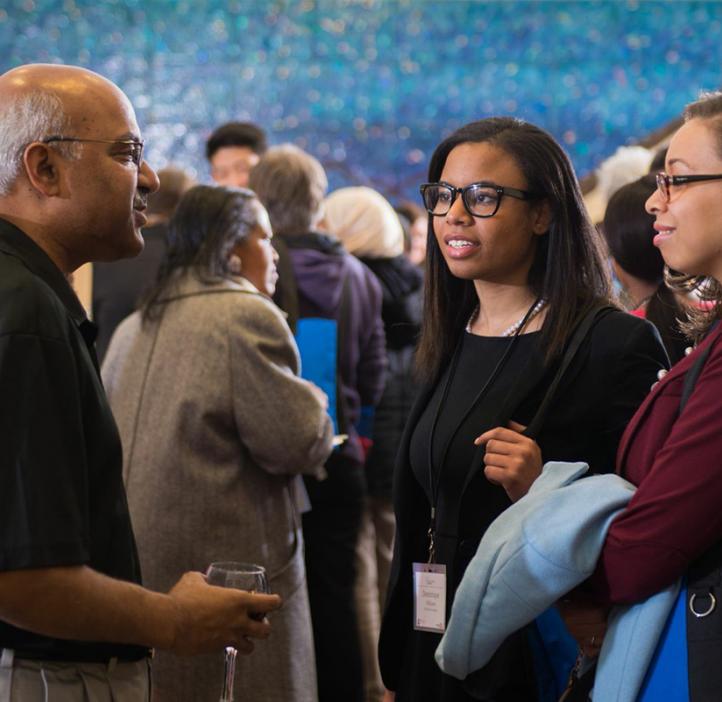 Sastry Pantula talking with female conference attendees