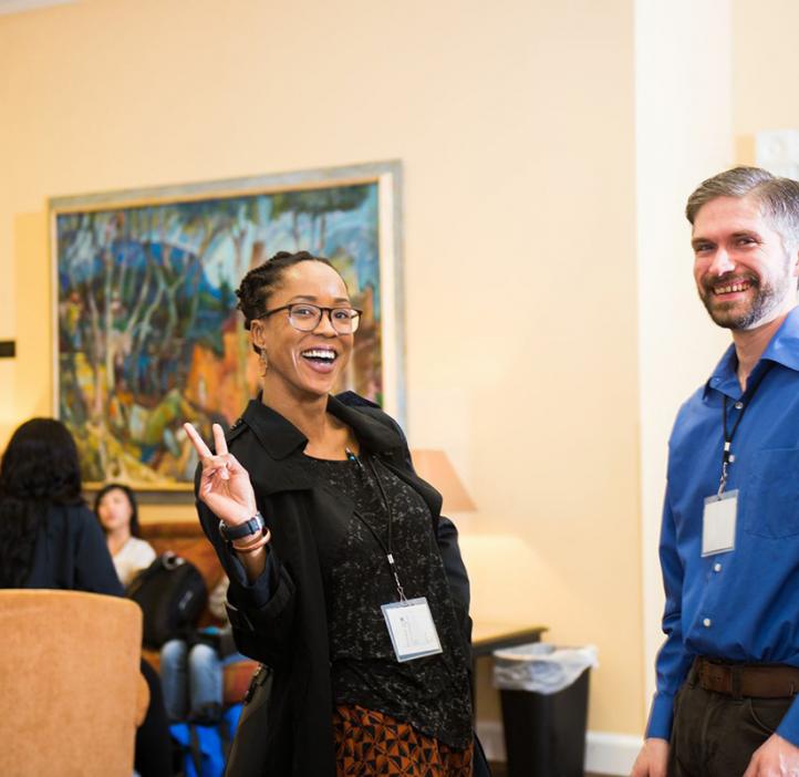 conference organizers and science faculty talking in lobby