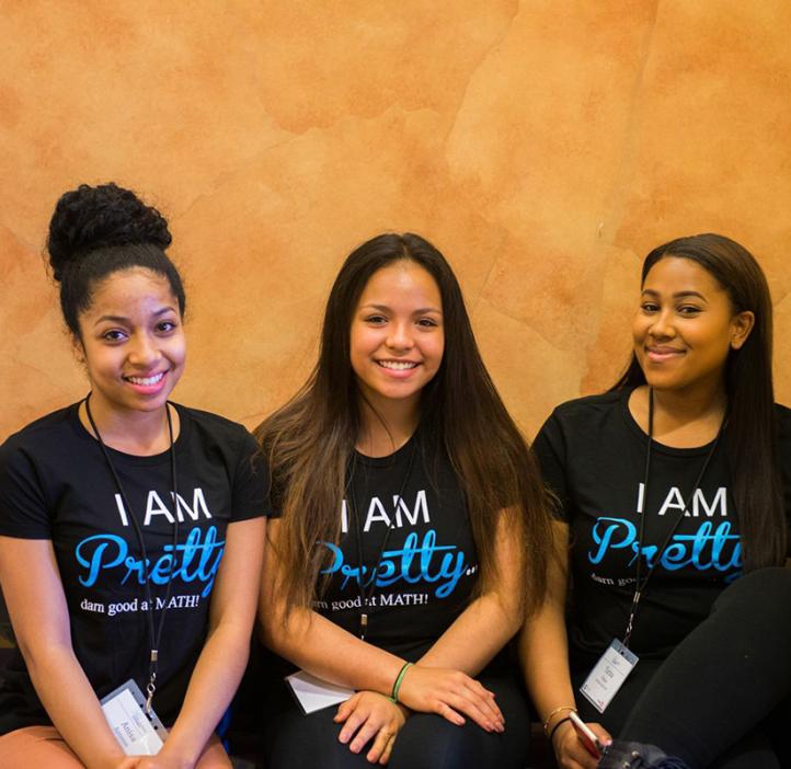 female students in event t-shirts on couch