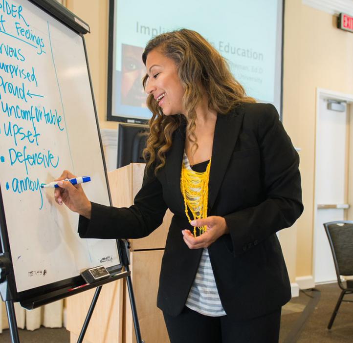 Tasha Henneman writing on whiteboard