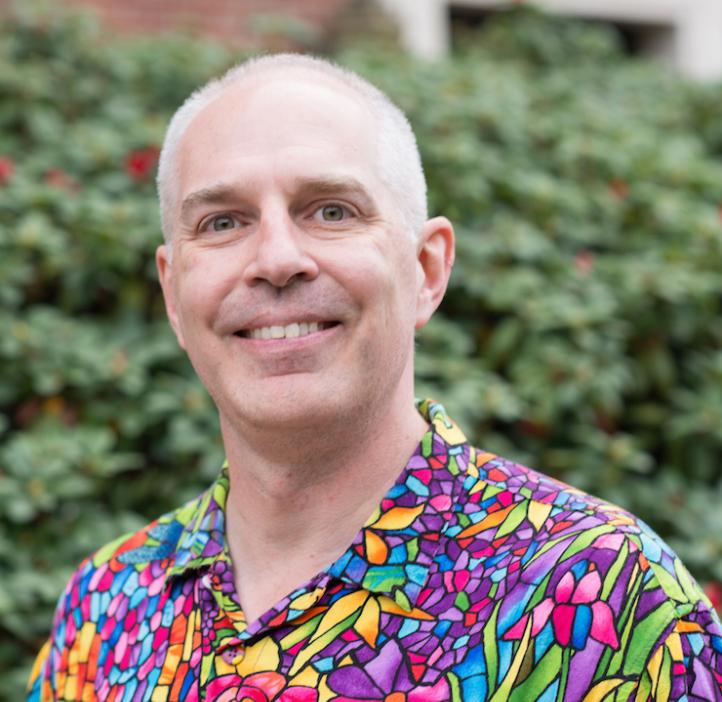 Mark Lavery, Biology instructor, in front of shrubbery