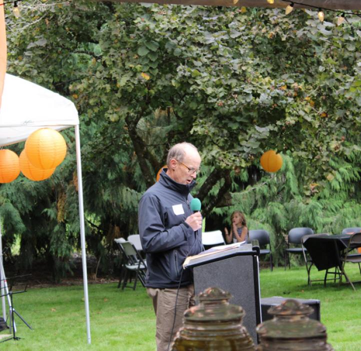 male faculty speaking to audience from podium
