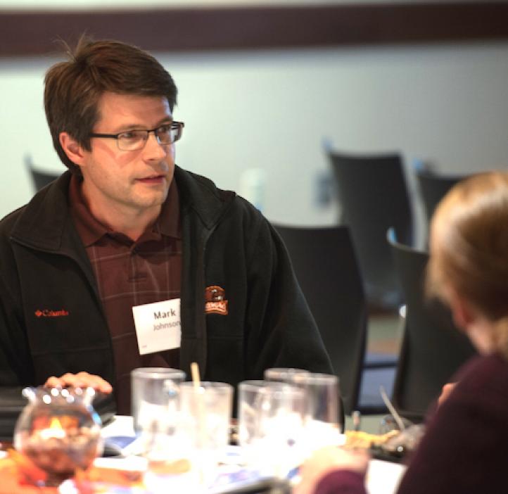 Mark Johnson, ASBC, sitting at table with family