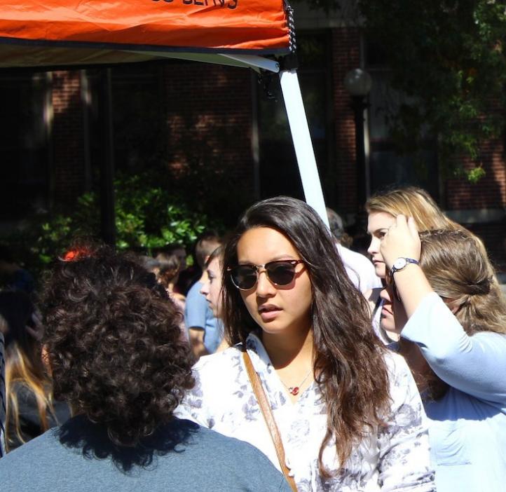 female students checking out science club booths