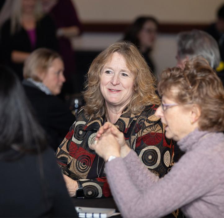 Attendee sitting at table and smiling