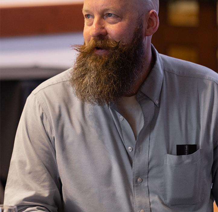 Chris Marshall smiles while sitting at table