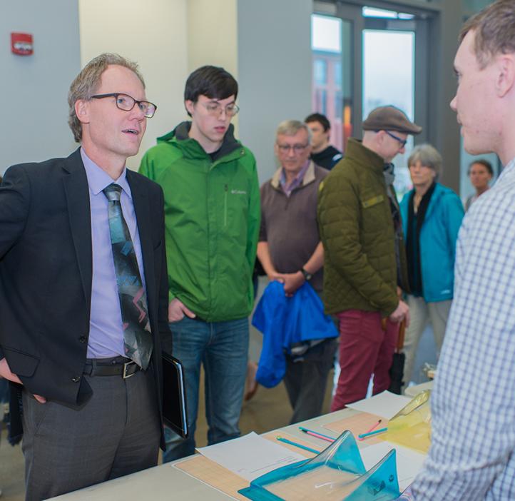 Roy Haggerty talking to a student during an event