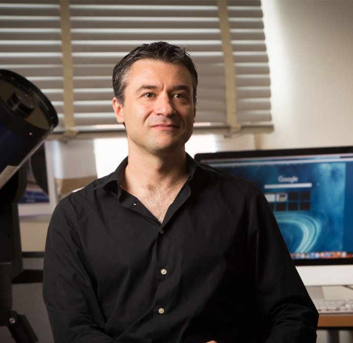 Department of Physics head Davide Lazatti sits in a well-lit office space.