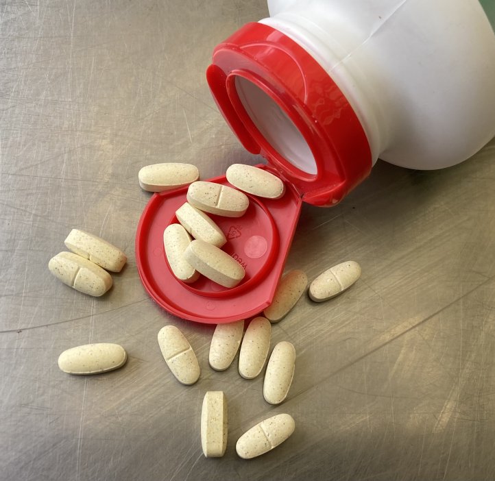 A spilled bottle of white pills.