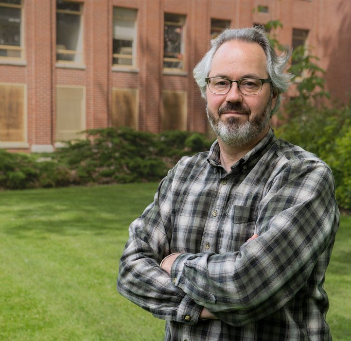 David Craig stands outside a brick building on OSU campus