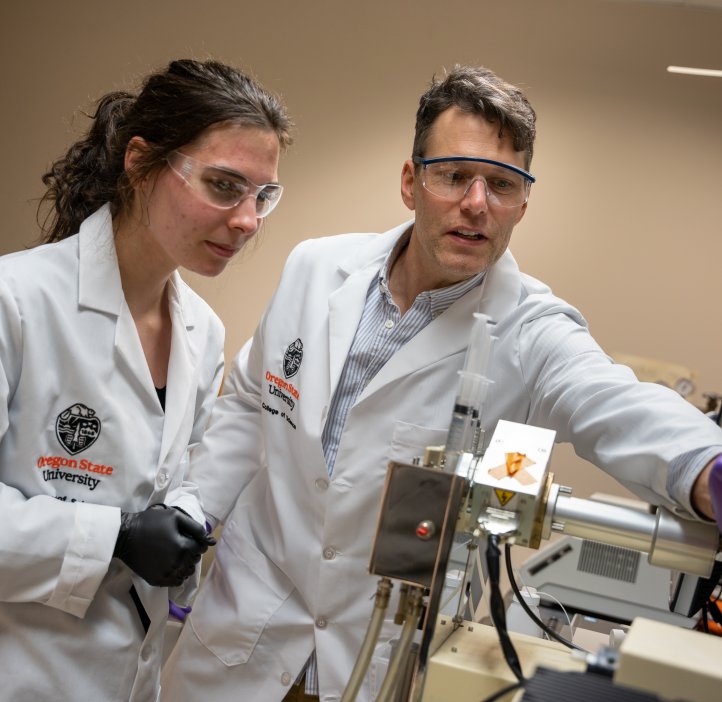 Two scientists use equipment in the GCE4All lab.
