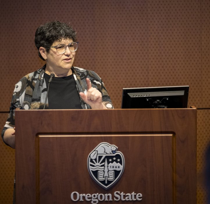 A woman stands at a platform.