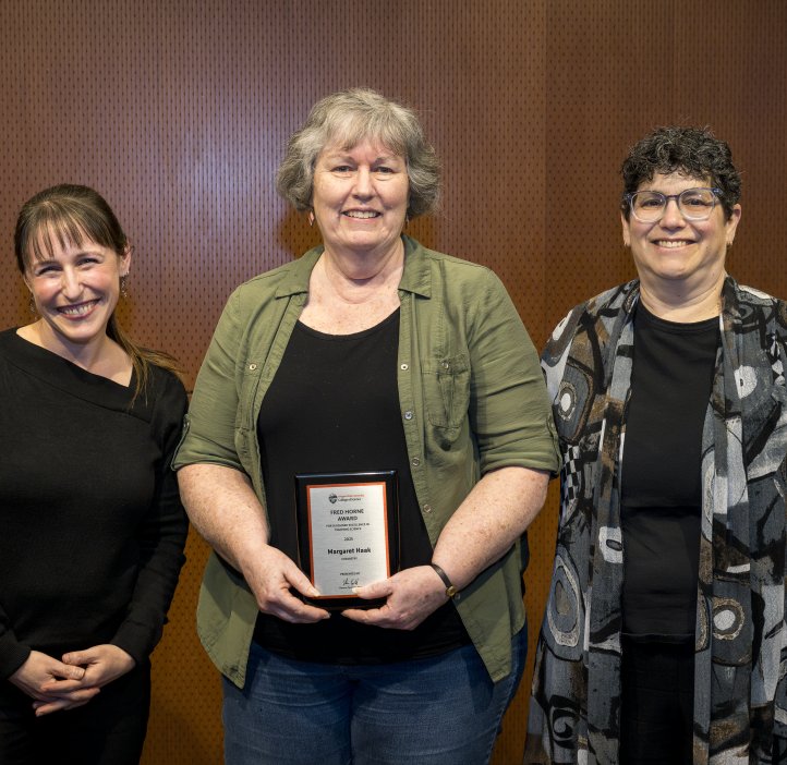 Jessica Siegel and Eleanor Feingold present an award to Maggie Haak.
