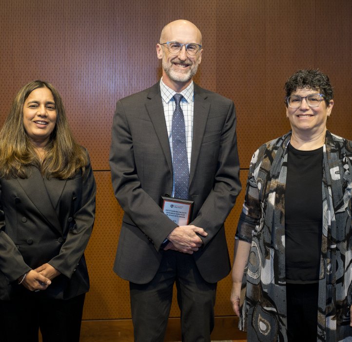 Vrushali Bokil and Eleanor Feingold present an award to Justin Preece.