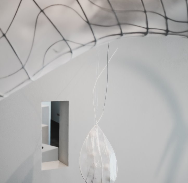 Paper artwork of fish parasite displayed on the ceiling. 