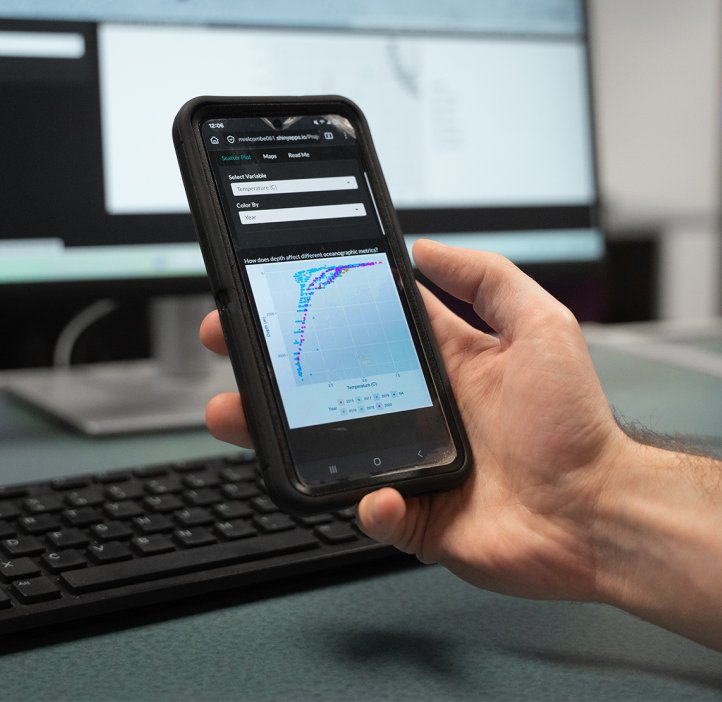 A hand holds a phone with an app open showing data points on a grid.