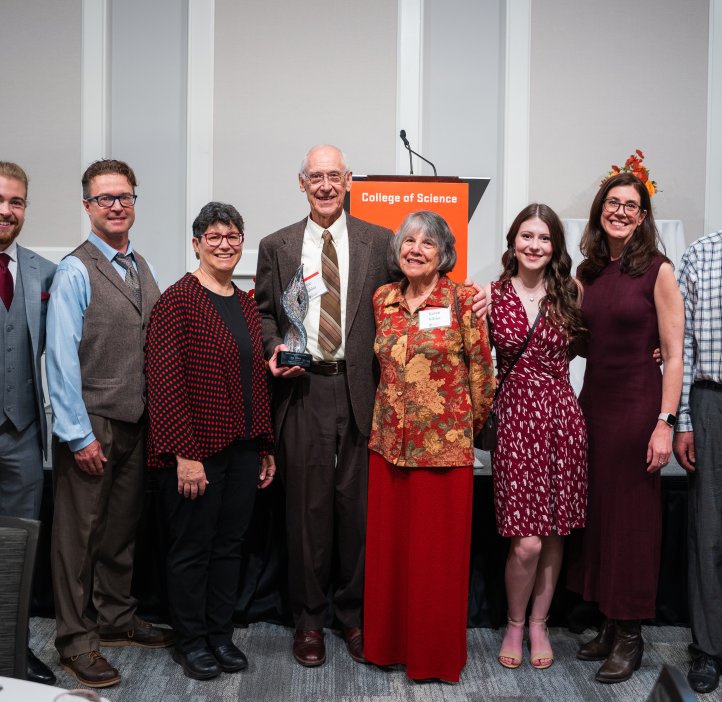 A group of people pose for a photo wearing nice clothes.
