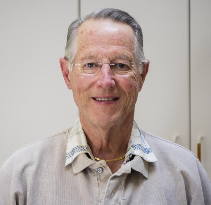 A man in grey shirt poses for photo.