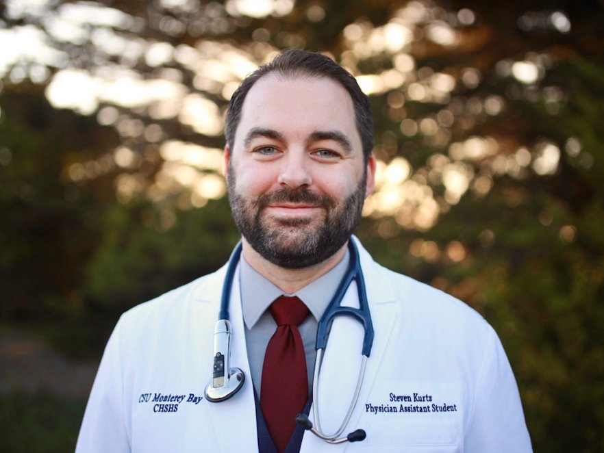 Steven Kurtz in a doctor coat and stethoscope