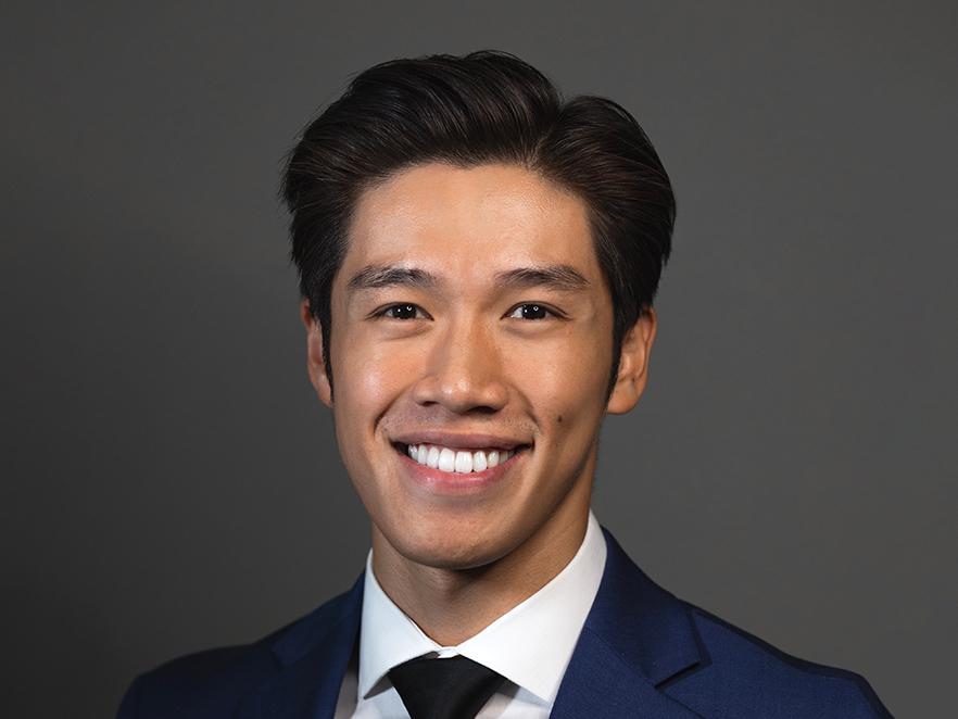 Daniel Trinh, a man with short black hair in a suit.