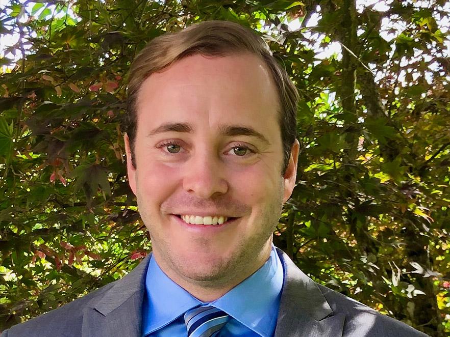 Nick Rosson, a man standing outside wearing a suit