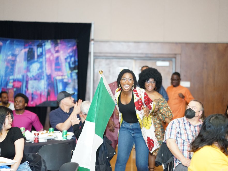 Ebunoluwa Morakinyo is seen dancing with an Nigerian flag during African night.