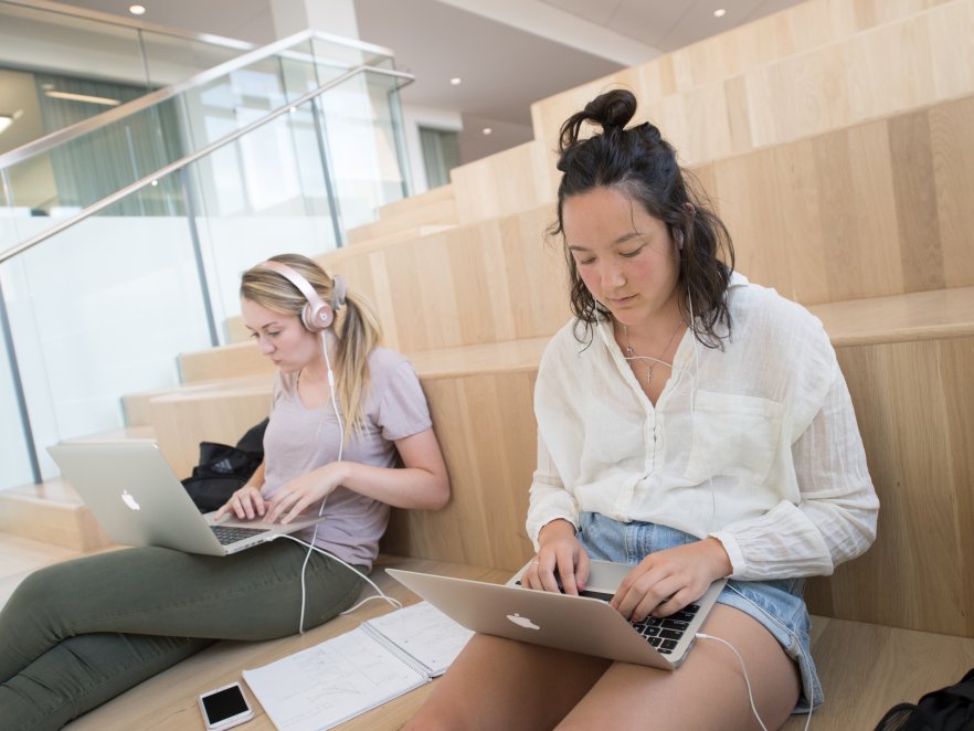 Two students work on laptops in the Learning Innovation Center